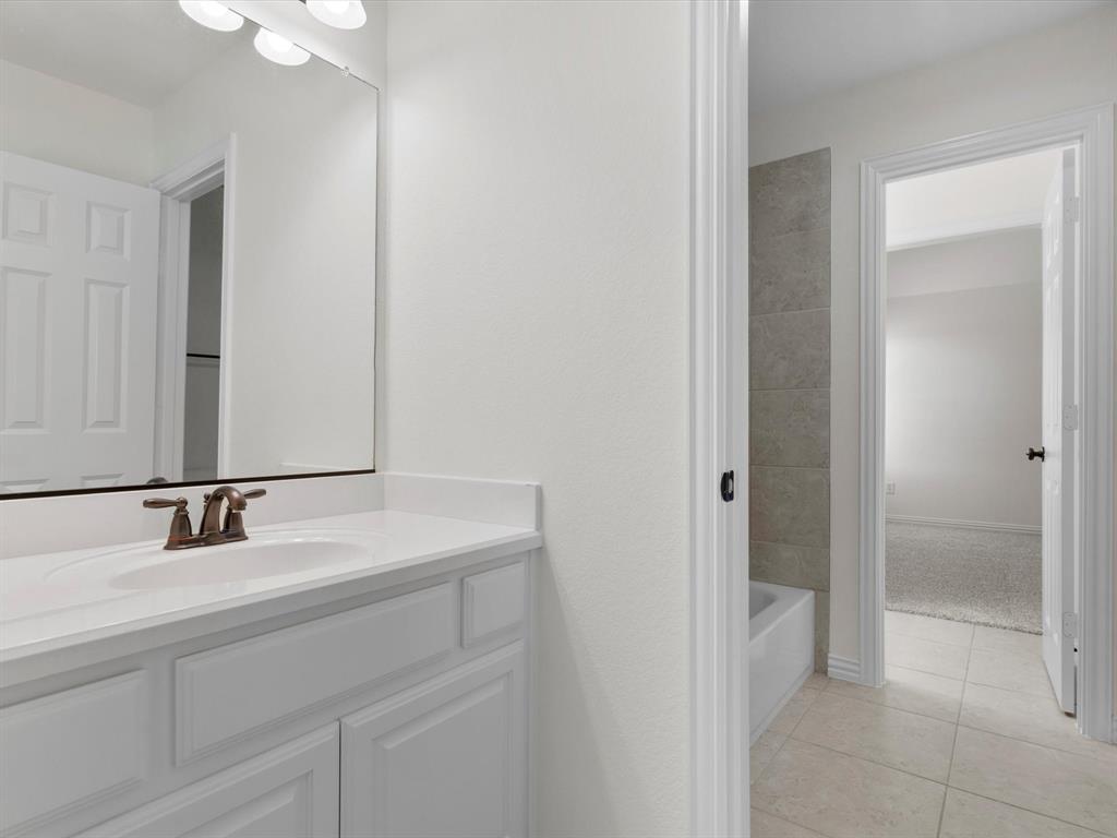13192 Mapleton Drive Frisco, TX 75035 - Photo 32 of 40 a bathroom with a sink and a mirror