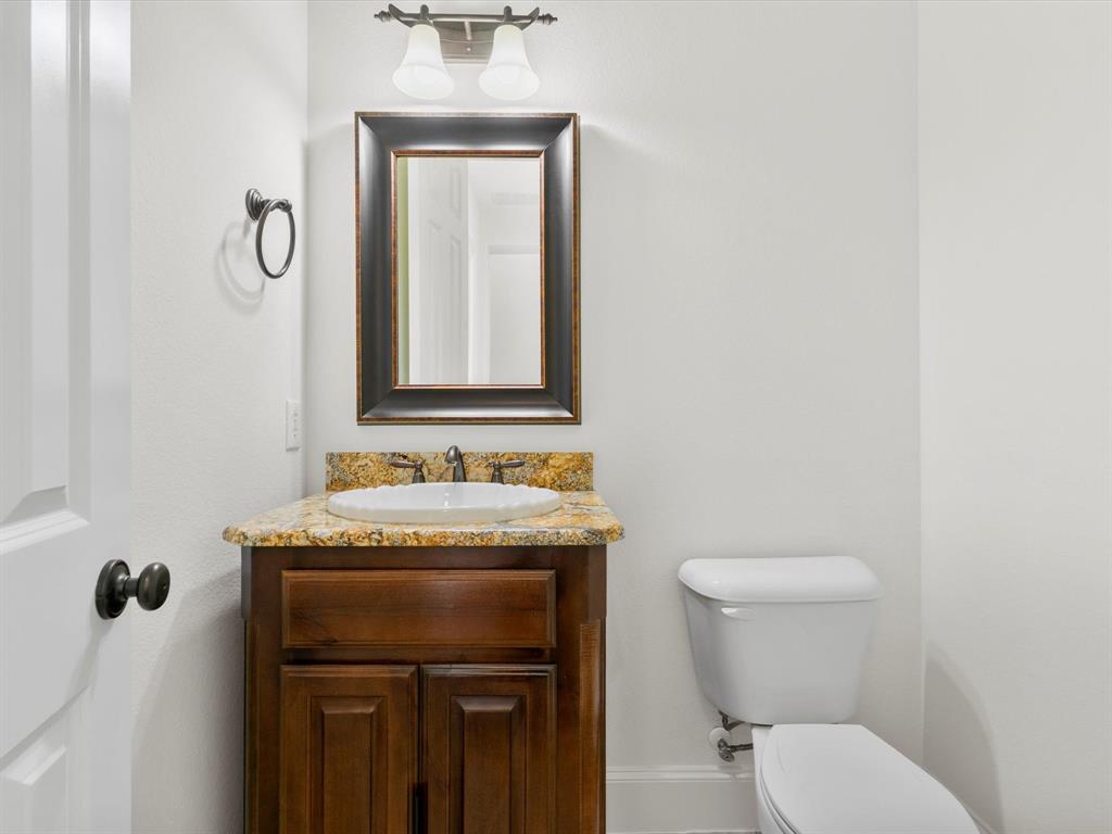 13192 Mapleton Drive Frisco, TX 75035 - Photo 6 of 40 a bathroom with a toilet sink and mirror