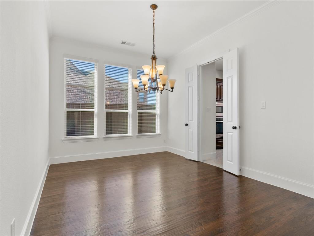 13192 Mapleton Drive Frisco, TX 75035 - Photo 7 of 40 a view of a room with wooden floor chandelier and windows