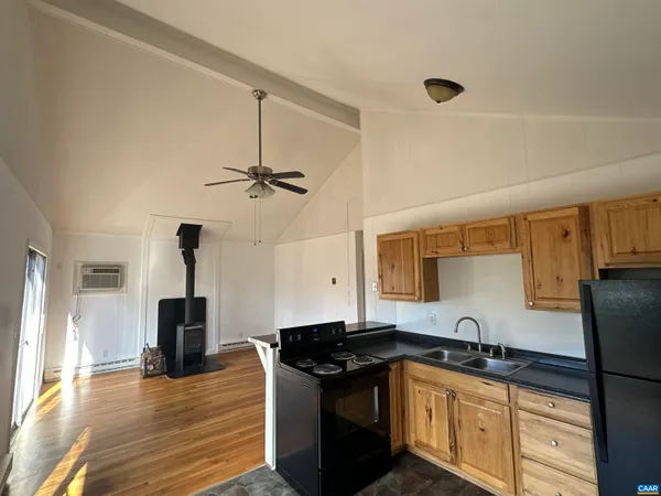 a kitchen with granite countertop a sink appliances and cabinets