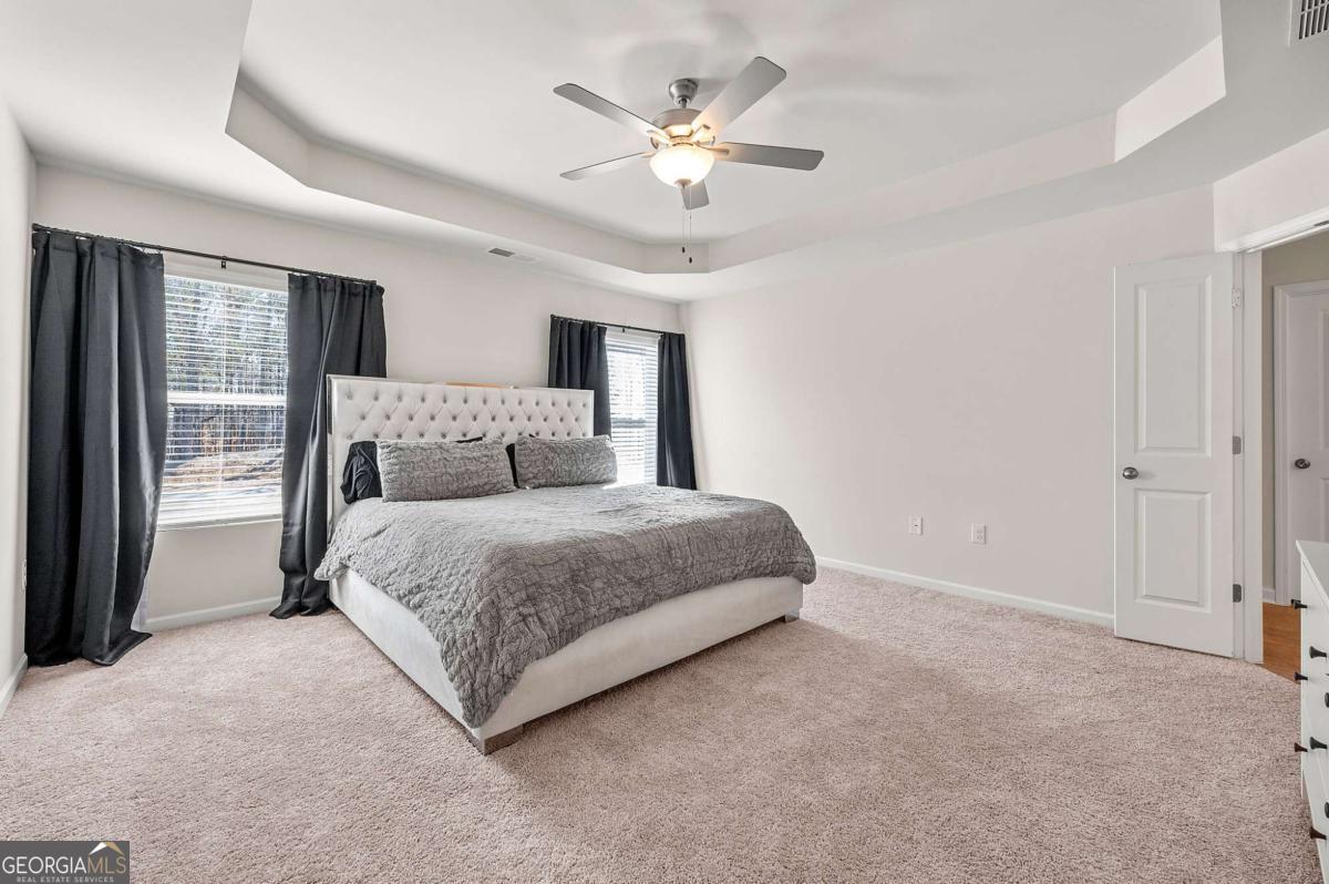 6372 Rosetta Drive Atlanta, GA 30331 - Photo 19 of 26 a bedroom with a large bed and a ceiling fan