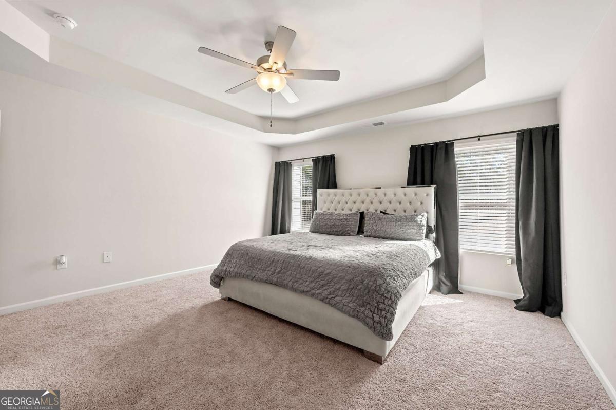 6372 Rosetta Drive Atlanta, GA 30331 - Photo 20 of 26 a spacious bedroom with a bed and a chandelier