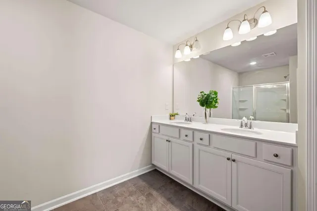 a bathroom with a sink vanity and a mirror