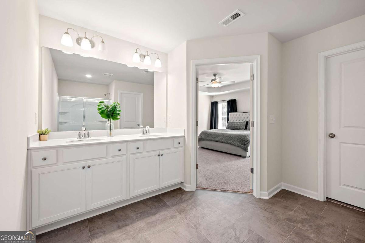 6372 Rosetta Drive Atlanta, GA 30331 - Photo 24 of 26 a spacious en suite bathroom with a double vanity sink and a mirror