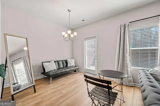 a living room with furniture and a wooden floor