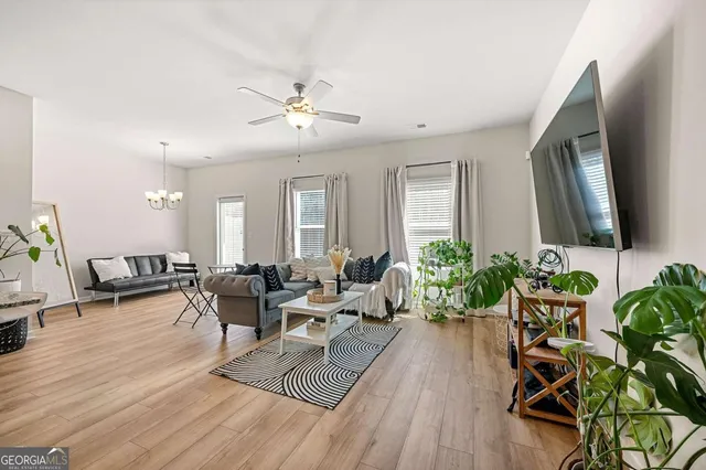a living room with furniture and a wooden floor