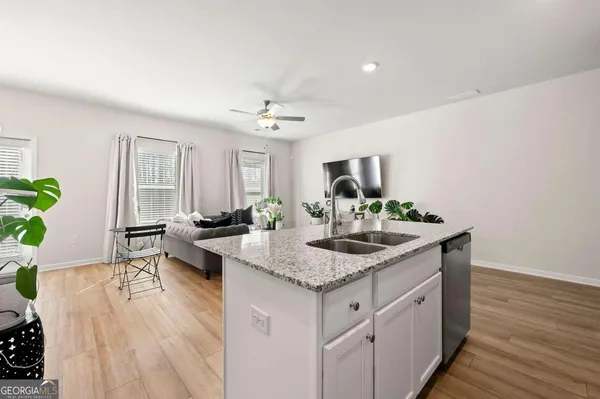 a kitchen with sink and mirror