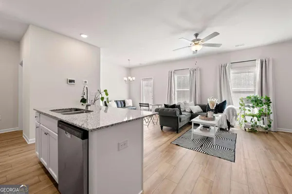 a living room with furniture and a wooden floor