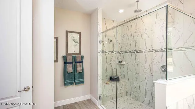 a bathroom with a granite countertop sink toilet a mirror and shower