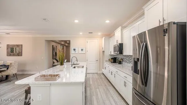 a living room with furniture and kitchen view