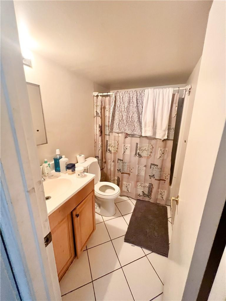 2401 Riverside Drive, Unit 309B Coral Springs, FL 33065 - Photo 2 of 9 a bathroom with a sink a toilet and a mirror