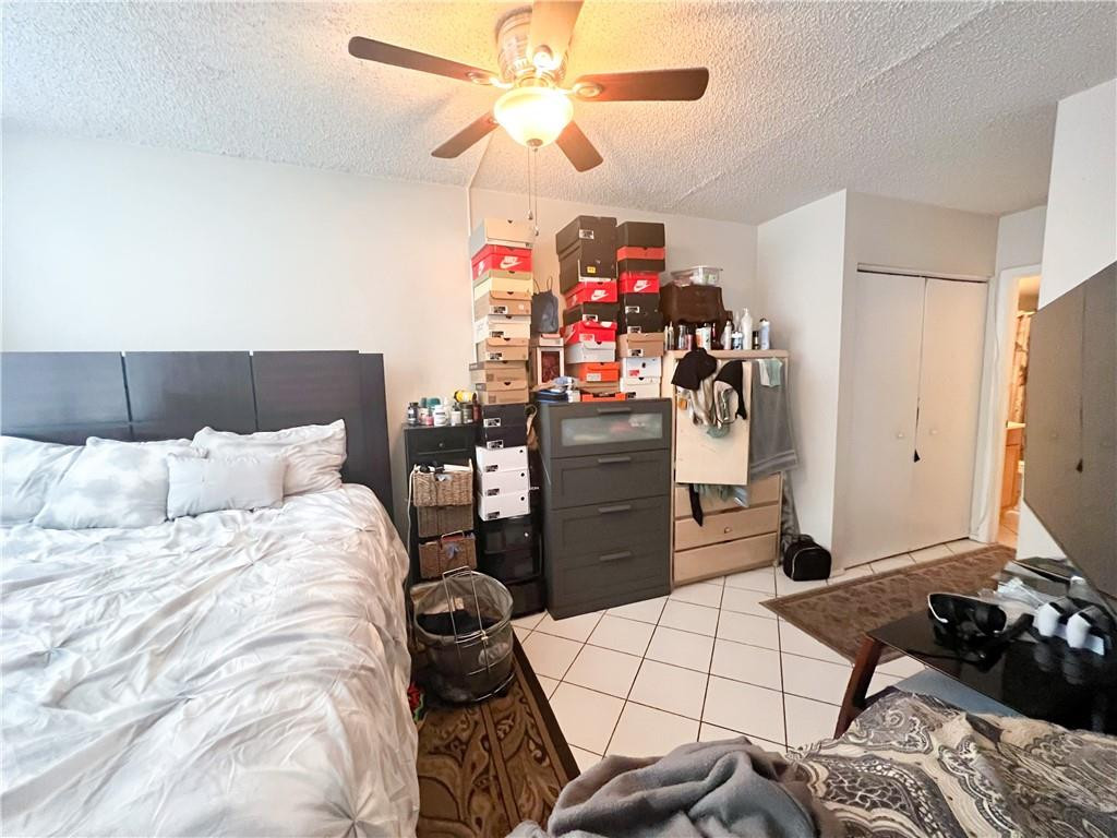 2401 Riverside Drive, Unit 309B Coral Springs, FL 33065 - Photo 3 of 9 a bed room with a bed and a television