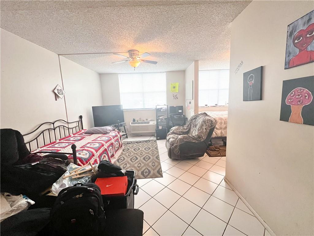 2401 Riverside Drive, Unit 309B Coral Springs, FL 33065 - Photo 4 of 9 a living room with furniture and a chandelier