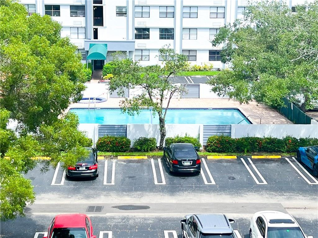 2401 Riverside Drive, Unit 309B Coral Springs, FL 33065 - Photo 7 of 9 a view of a cars park in front of a building