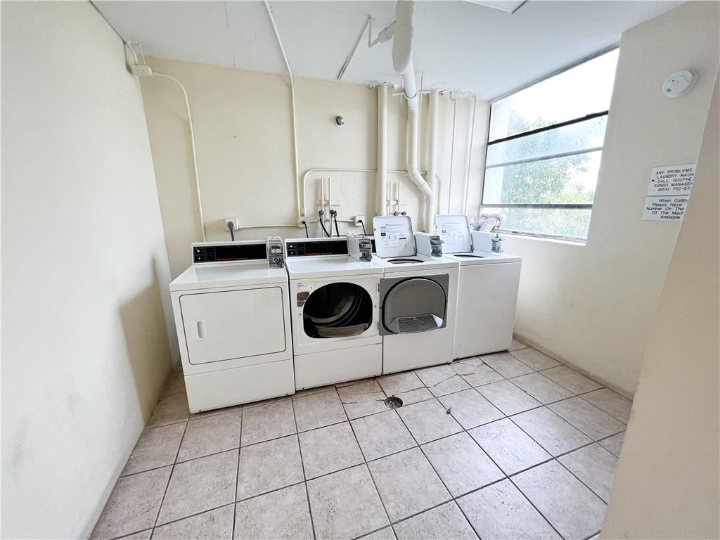 2401 Riverside Drive, Unit 309B Coral Springs, FL 33065 - Photo 9 of 9 a utility room with cabinets washer and dryer