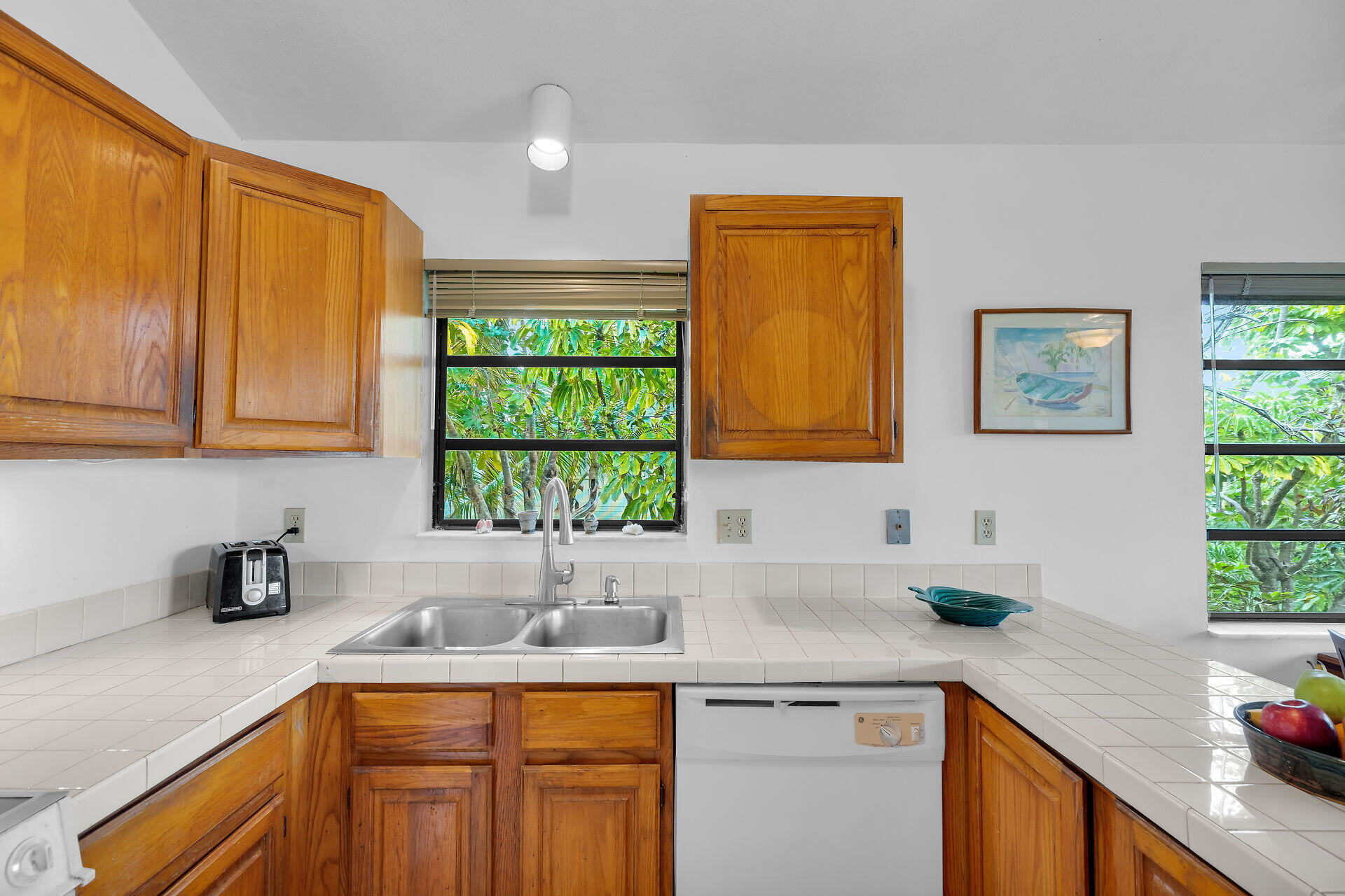 683 Blackbeard Road Summerland Key, FL 33042 - Photo 15 of 49 a kitchen with stainless steel appliances granite countertop a sink a stove cabinets and a window