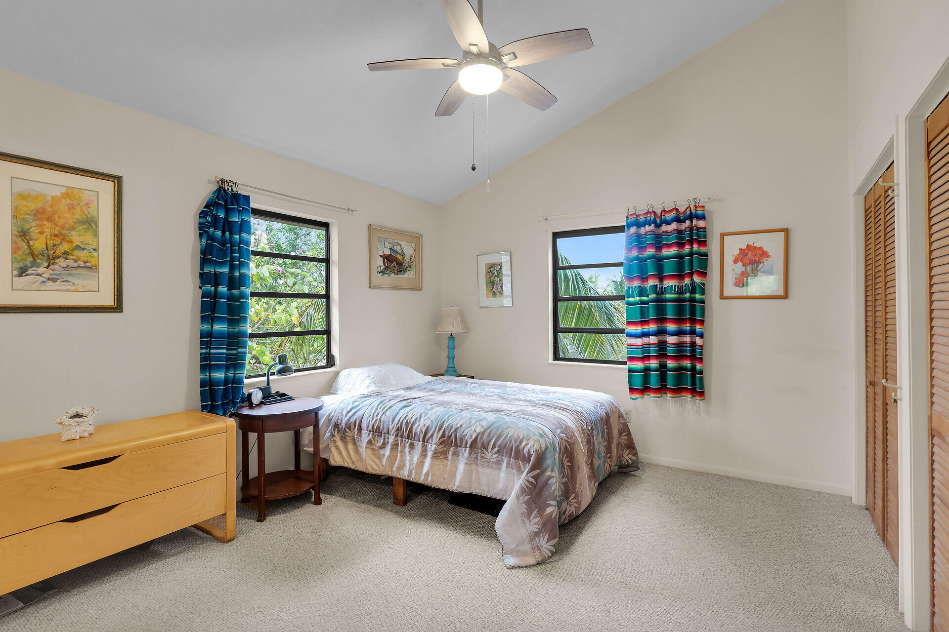683 Blackbeard Road Summerland Key, FL 33042 - Photo 20 of 49 a bedroom with a bed and a chandelier