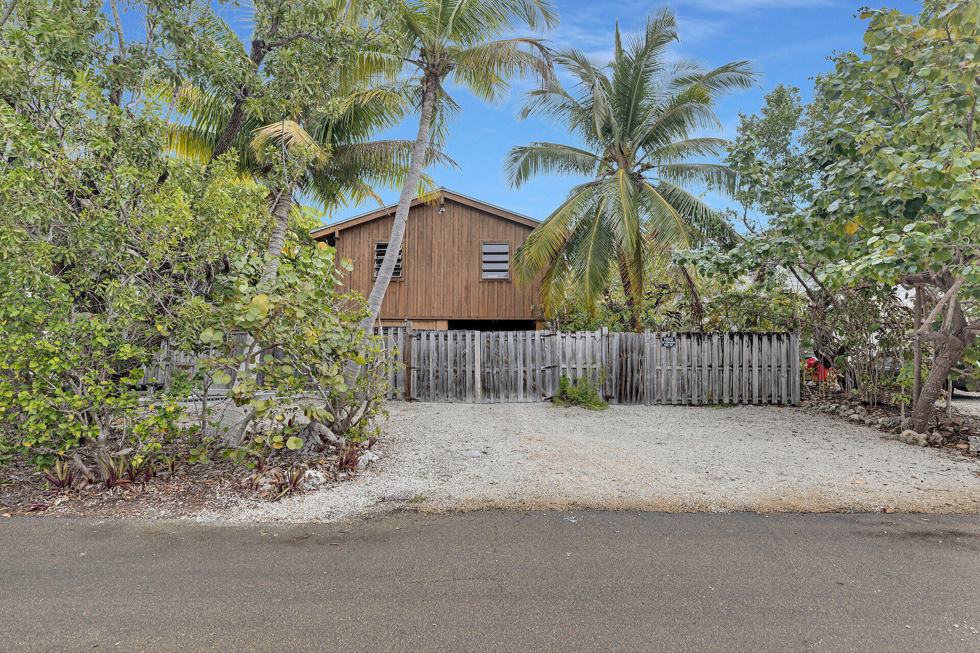 683 Blackbeard Road Summerland Key, FL 33042 - Photo 9 of 49 a view of a house with a small yard and plants