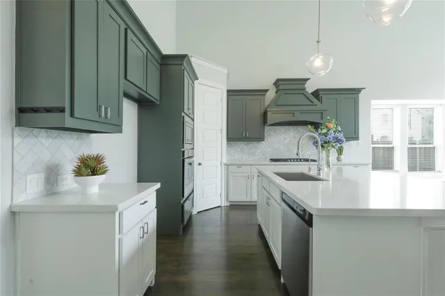 a kitchen with a sink and cabinets