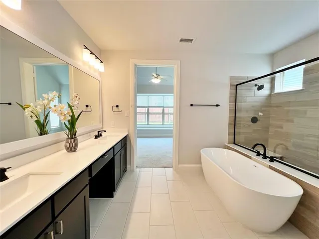 a spacious bathroom with a bathtub and sink