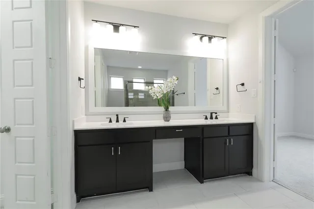 a bathroom with a double vanity sink and a mirror