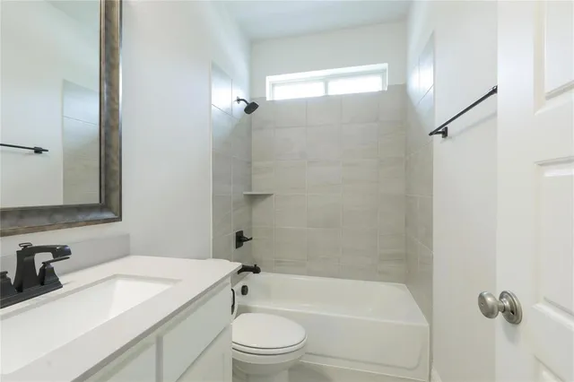 a bathroom with a sink a toilet and a bathtub