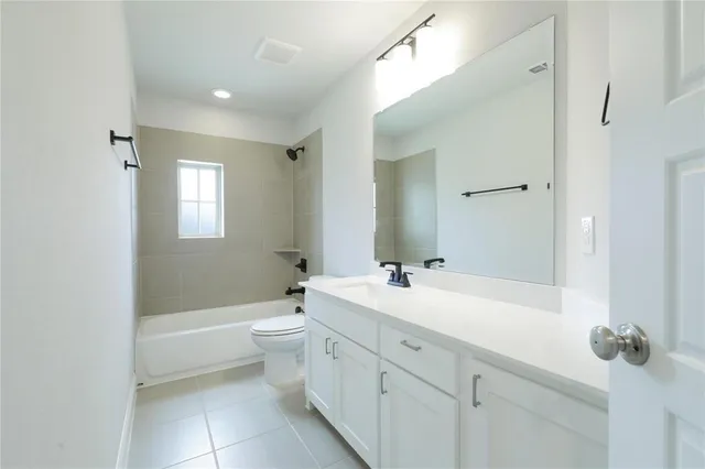 a bathroom with a double vanity sink toilet mirror and bathtub