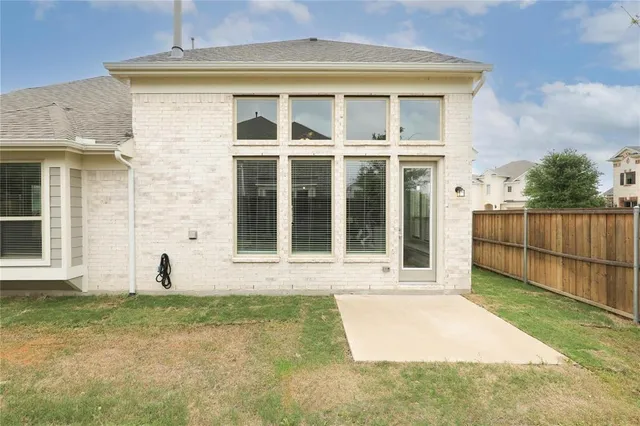 a view of a brick house with many windows