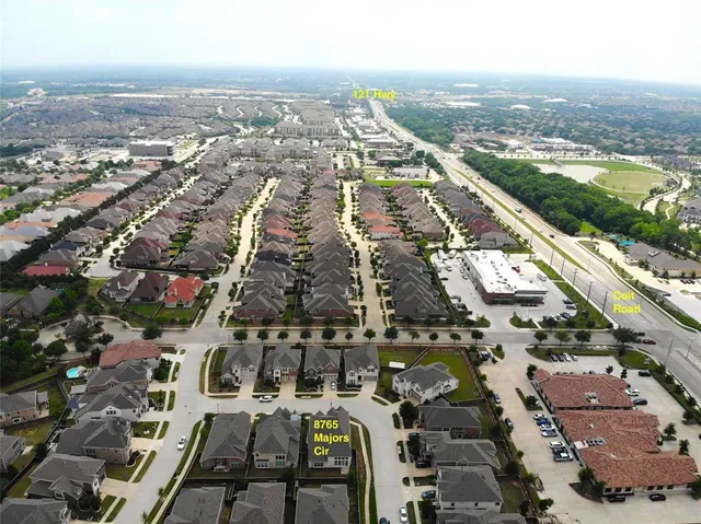 an aerial view of a city with parking