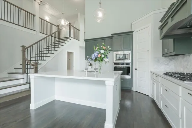 a kitchen with cabinets and stainless steel appliances