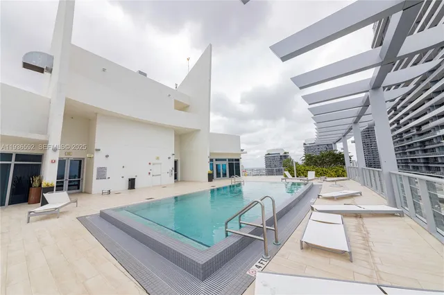 a view of swimming pool with outdoor seating and city view