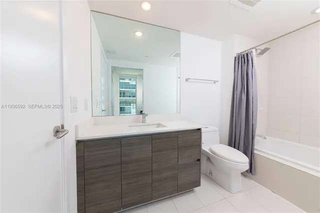 a bathroom with a double vanity sink toilet and shower