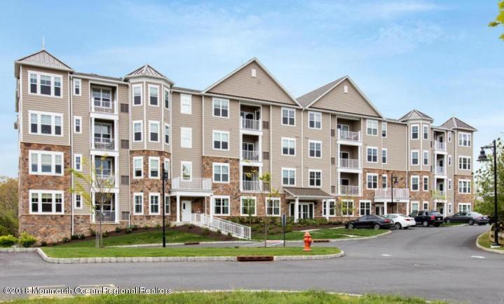2201 River Road, Unit 4307 Point Pleasant, NJ 08742 - Photo 1 of 21 a front view of a building with street parked