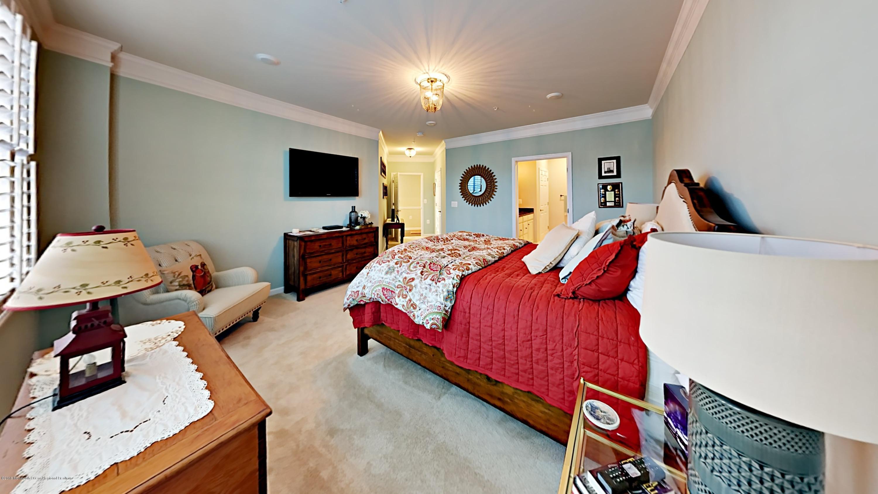 2201 River Road, Unit 4307 Point Pleasant, NJ 08742 - Photo 12 of 21 a bedroom with bed and a flat screen tv