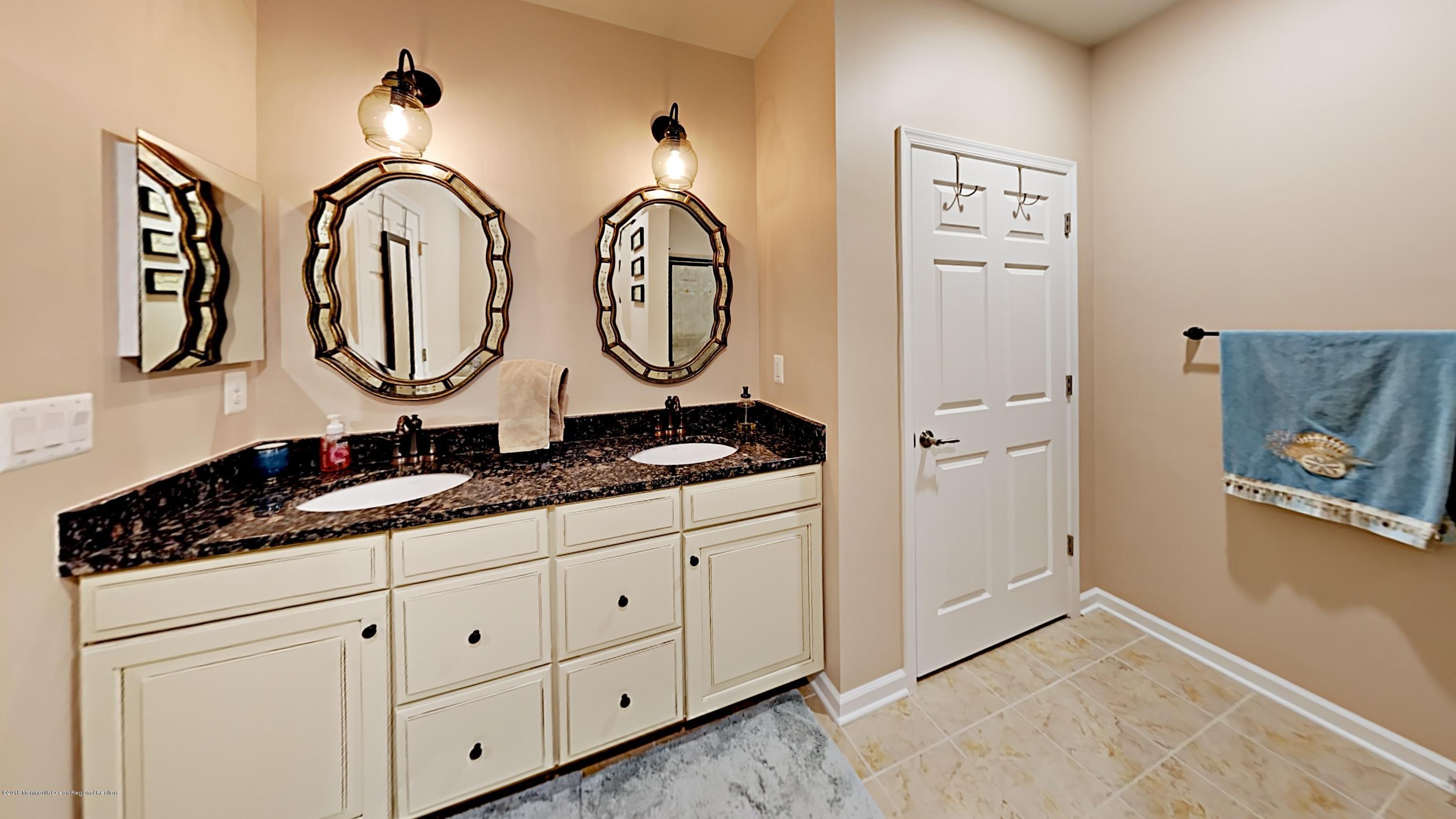 2201 River Road, Unit 4307 Point Pleasant, NJ 08742 - Photo 13 of 21 a bathroom with a granite countertop double vanity sink and a mirror