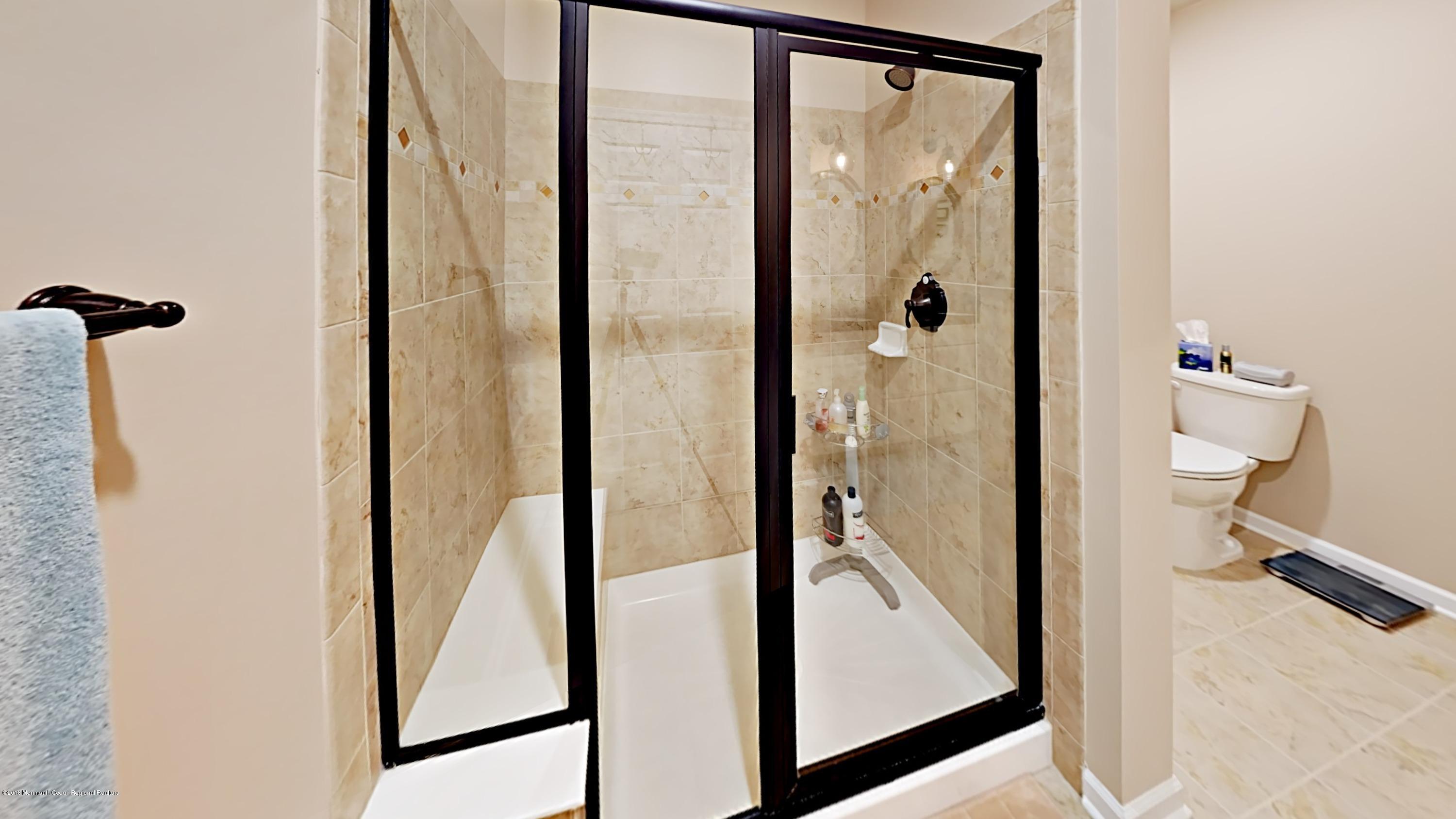 2201 River Road, Unit 4307 Point Pleasant, NJ 08742 - Photo 14 of 21 a view of a bathroom with a glass door