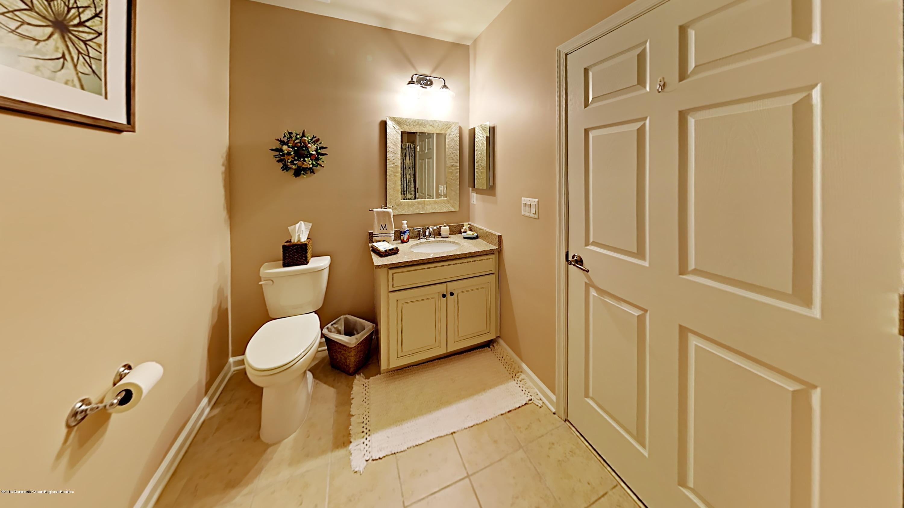 2201 River Road, Unit 4307 Point Pleasant, NJ 08742 - Photo 17 of 21 a bathroom with a sink a toilet and shower