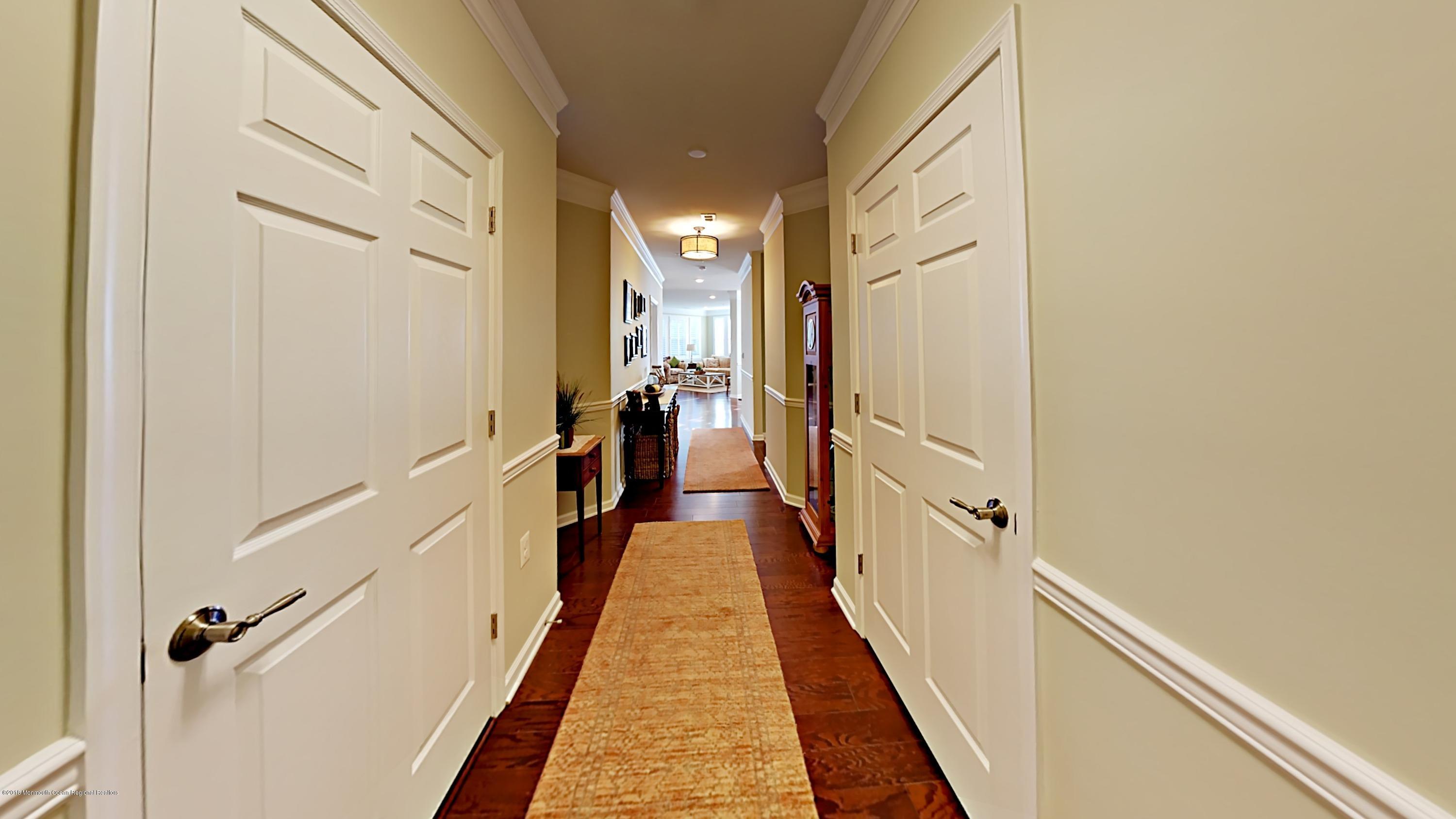 2201 River Road, Unit 4307 Point Pleasant, NJ 08742 - Photo 4 of 21 a view of a hallway with wooden floor and staircase