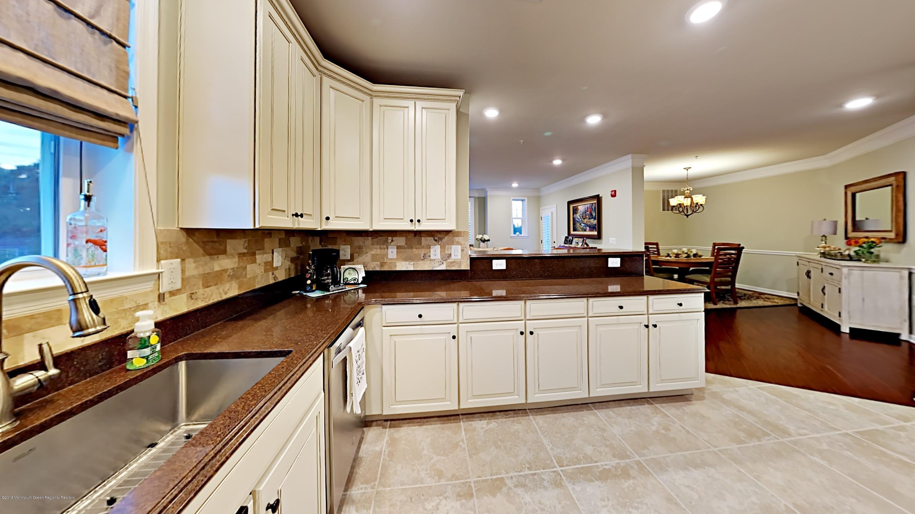 2201 River Road, Unit 4307 Point Pleasant, NJ 08742 - Photo 7 of 21 a kitchen with stainless steel appliances granite countertop a sink a stove counter space and cabinets