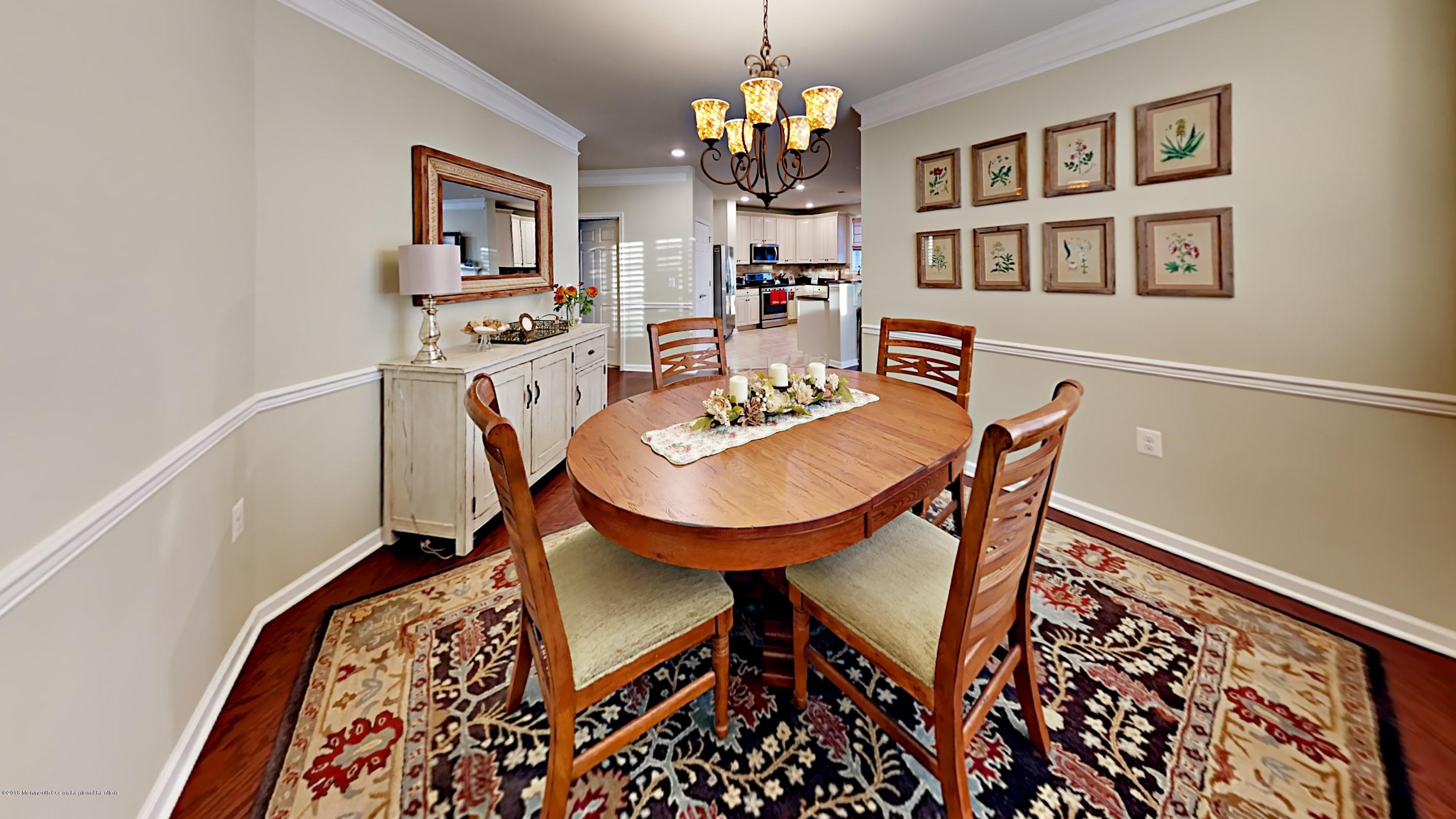 2201 River Road, Unit 4307 Point Pleasant, NJ 08742 - Photo 10 of 21 a view of a dining room with furniture and a rug