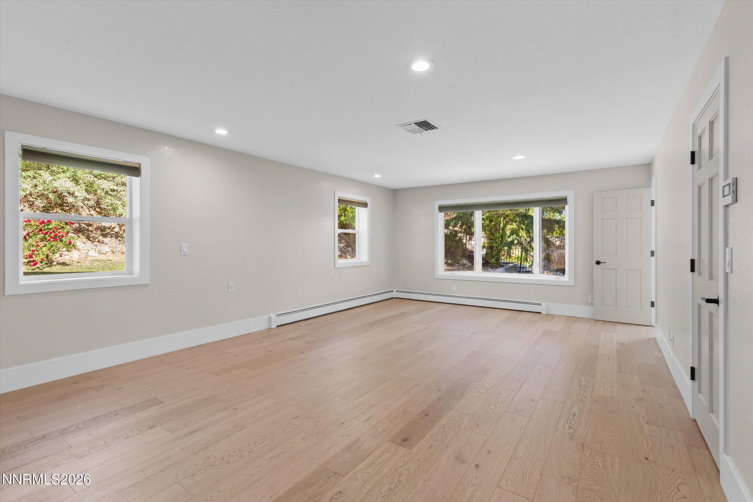 2725 West Lake Ridge Shores Reno, NV 89519 - Photo 21 of 49 an empty room with wooden floor and windows