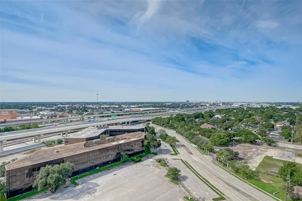 a front view of a building with a garden and plants
