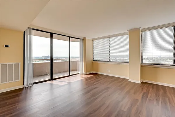 a view of kitchen with wooden floor and electronic appliances