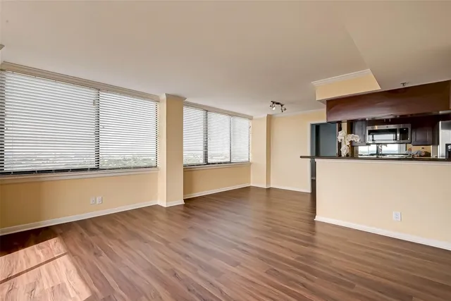 a view of a kitchen with wooden floor and a refrigerator