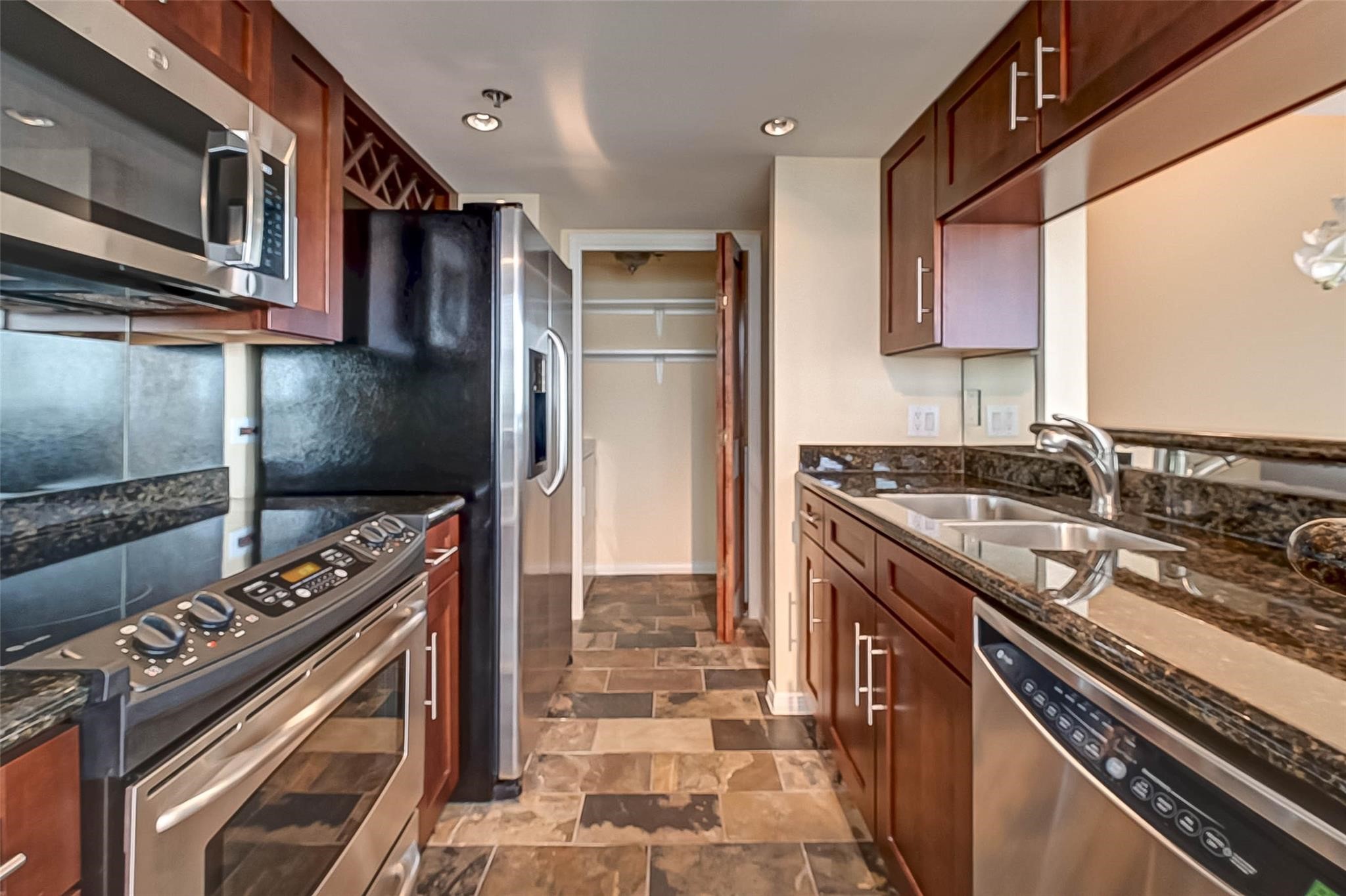 3525 Sage Road, Unit 1703 Houston, TX 77056 - Photo 23 of 43 a kitchen with a stove and a microwave
