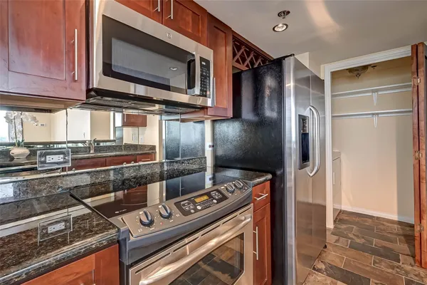 a kitchen with a sink cabinets and wooden floor