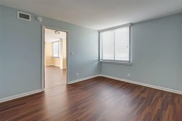 a bathroom with a granite countertop sink toilet and a mirror