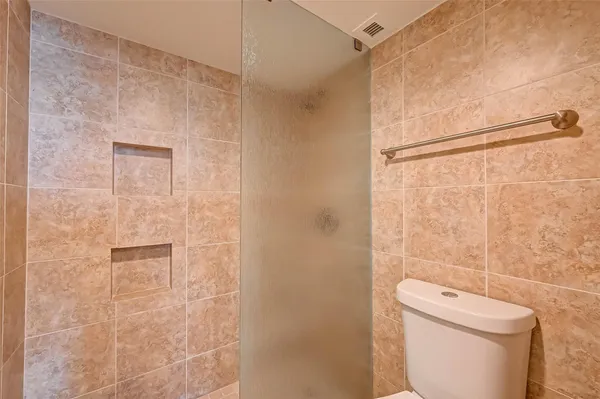 a white bath tub sitting next to a toilet