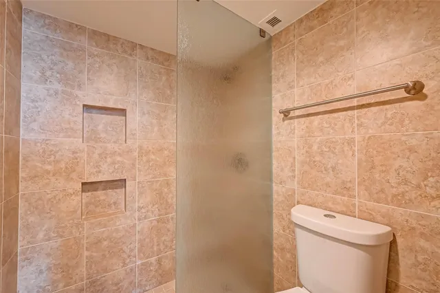 a white bath tub sitting next to a toilet