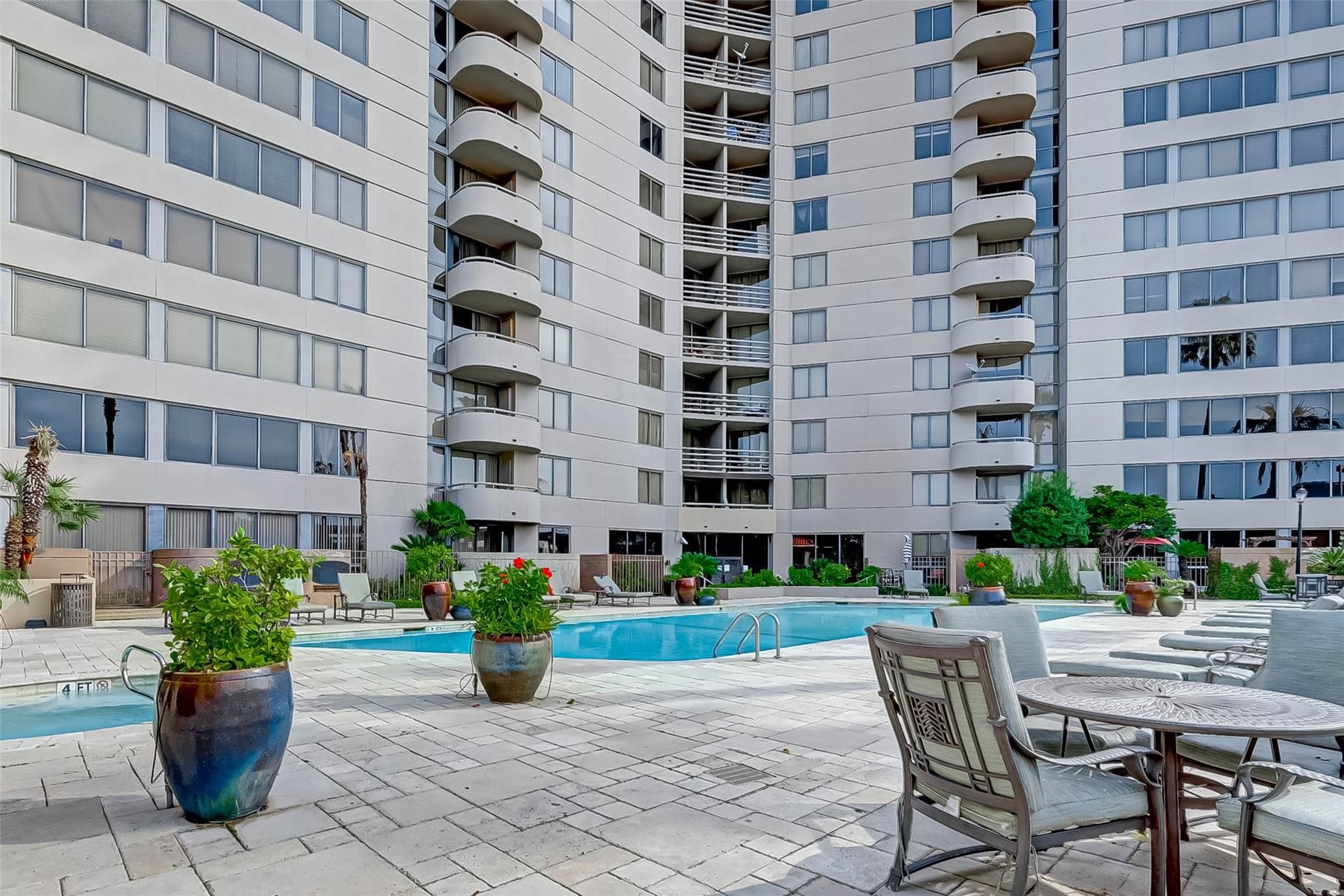3525 Sage Road, Unit 1703 Houston, TX 77056 - Photo 4 of 43 a view of a building with garden space and potted plants